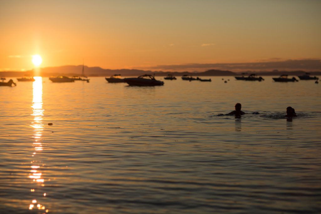 Swimmers in the warm water at sunset, Savary Island